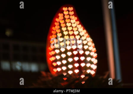 Silhouette of a fire with lights shaped as hearts, everything blurred. With copyspace. Stock Photo