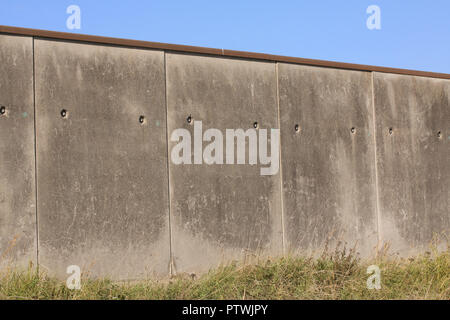 Border or prison cement gray concrete wall against a blue sky with copy space Stock Photo
