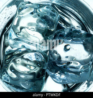 Close up of ice cubes in drinking glass with reflections Stock Photo