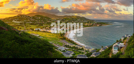 Panorama of Saint Kitts and its capital Basseterre during sunset, beautiful green mountains and a beach in paradise caribbean island with amazing gree