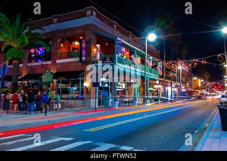 Tampa, FL—Oct 2, 2018; time exposure of cars traveling through Ybor city at night.  Ybor is a registered cigar manufacturing historic district. Stock Photo