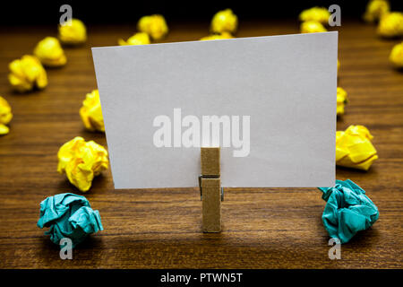 Business concept Empty template copy space isolated Posters coupons promotional material. Written notepad stand with paperclip yellow lobs in front bl Stock Photo