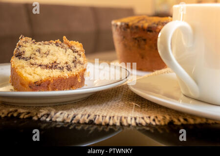 Brazilian anthill Cake (Formigueiro) and cup of coffee on a table served for coffee break Stock Photo