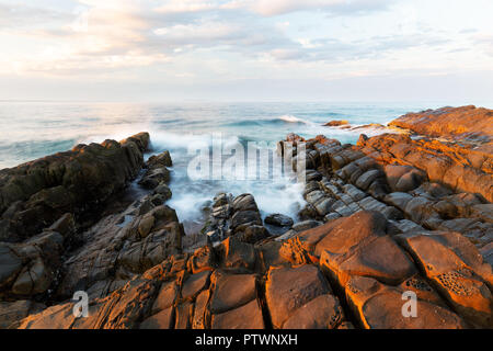 Sunrise on coast of sea Stock Photo