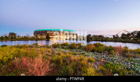 Optus Stadium surrounded by a lake and parkland. Stock Photo