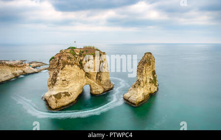 Rouche rocks in Beirut, Lebanon near sea and during sunset. Cloudy day in Beirut Lebanon Stock Photo