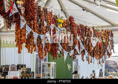 One of (9) images relating to various vegetables for sale on stalls in Munich's Market. Dried Chillies are priced in Euros and are in German language. Stock Photo