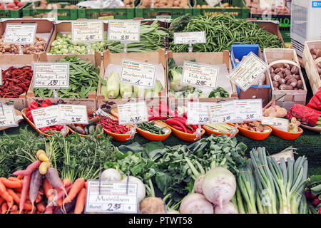 One of (9) images relating to various vegetables for sale on stalls in Munich's Market. Vegetable seen are priced in Euros and are in German language. Stock Photo