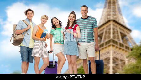 friends with travel bags over eiffel tower Stock Photo