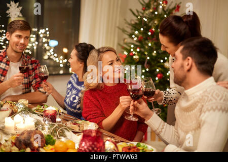 friends celebrating christmas and drinking wine Stock Photo