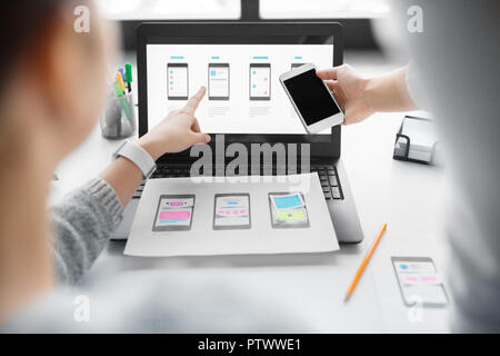 web designers work on smartphone user interface Stock Photo