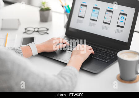 web designer with laptop working on user interface Stock Photo