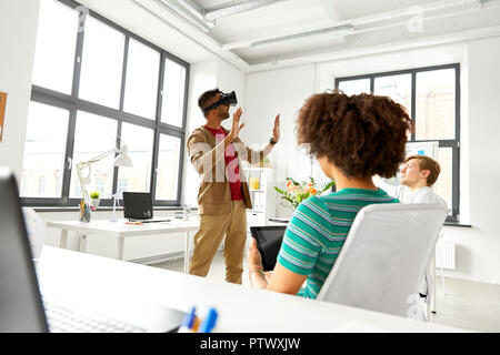 developers with virtual reality headset at office Stock Photo