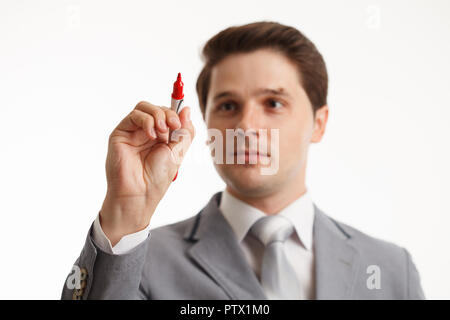 Businessman writing or drawing on screen, in front of white background Stock Photo