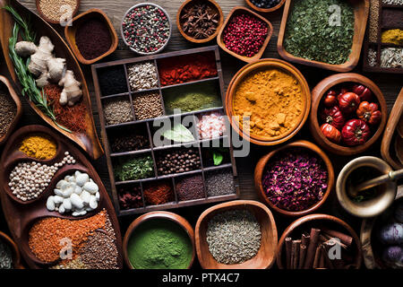 Colored spice background. Spices and herbs top view. Wooden background. Stock Photo
