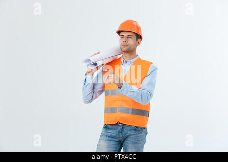Supply of building materials concept. Engineer, architect on busy face ,holds blueprints, pointing with finger, copy space. Stock Photo
