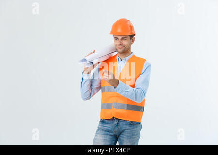 Supply of building materials concept. Engineer, architect on busy face ,holds blueprints, pointing with finger, copy space. Stock Photo