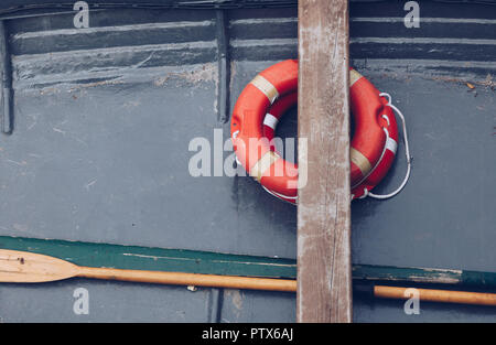close up of a old little boat with buoy orange - life ring - marine mood Stock Photo