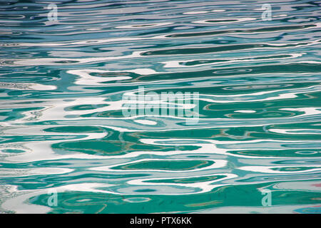 Abstract sun glare reflections on sea water surface background Stock Photo