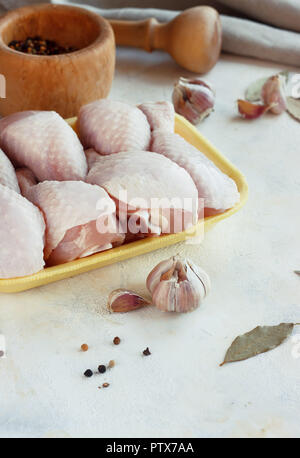 fresh raw chicken pieces on a light background in a tray Stock Photo