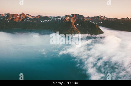 Landscape mountains range and blue sea with clouds sunset scenery in Norway aerial drone view Travel beautiful locations exploring Senja islands Stock Photo