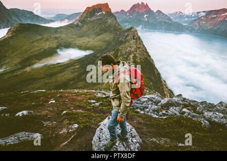 Man with backpack hiking alone in mountains Traveling heathy lifestyle adventure concept active summer vacations outdoor trail Stock Photo