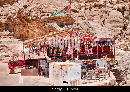 A small tent with a cooler provides shade and acts as a small cafe and rest stop on the long climb to the Monastery at Petra. Stock Photo