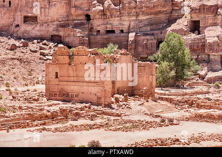 The ruins of the Temple of Dushares at the end of the Roman Colonnade stand under some of the tombs in the cliff walls of Petra in Jordan. Stock Photo