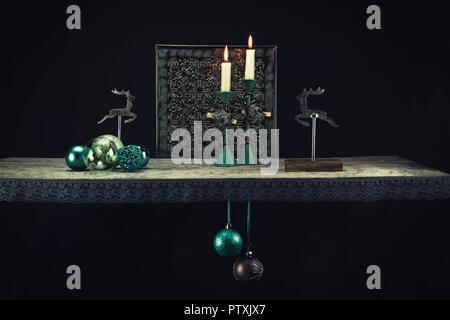 Christmas decoration elements in warm turquoise tones against a dark background. In addition to turquoise, dark brown, wood and old silver create a Ch Stock Photo