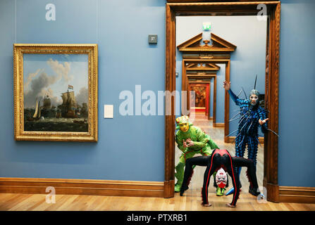 Perfromers from the current Cirque du Soleil show OVO (from left) Weiliang Wu 'The Cricket', Alanna Baker 'Black Spider' and Jan Dutler 'The Foreigner', during a visit to the National Gallery of Ireland to view the Gallery's exhibition Circus250: Art of the Show. Stock Photo