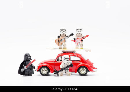 lego darth vader watching storm troopers singing and two of them playing guitar on car roof. Stock Photo