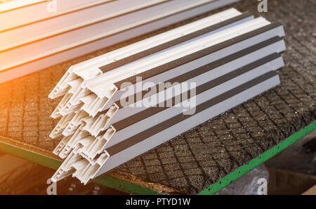 Production of pvc windows, plastic pvc profile lies on the table, close-up, section Stock Photo