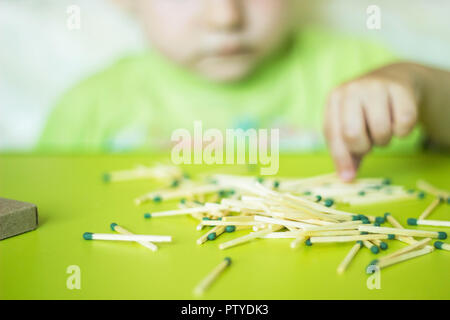 Little baby girl playing with matches, baby and matches, fire, lucifer match Stock Photo