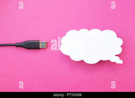 Cloud for data storage cut from paper on a pink background and cable usb, close-up, data storage on the Internet Stock Photo