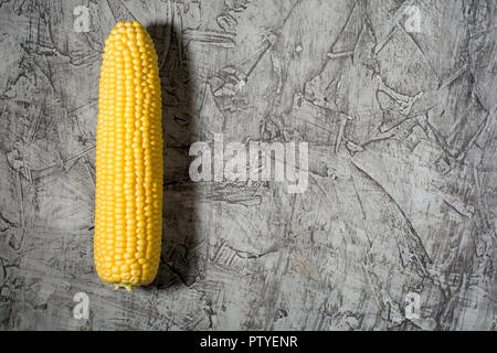 top view of fresh corn cob on a gray concrete table, top view Stock Photo