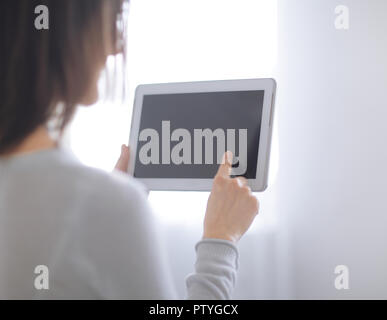 close up. woman pressing her finger on the digital tablet screen .photo with copy space Stock Photo
