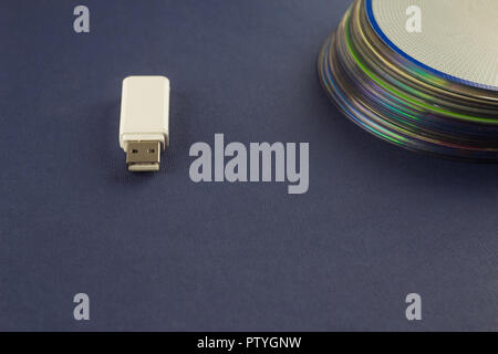 White flash drive and a stack of CD, DVD, computer Stock Photo