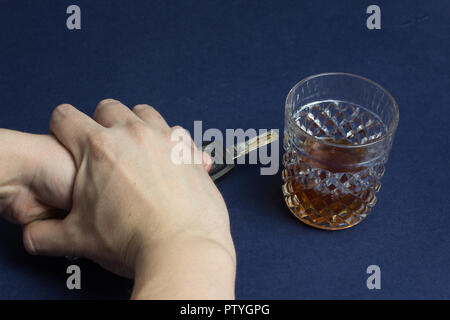 Alcohol and car keys, hands, ban, female hand holds a man's hand Stock Photo