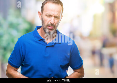 Middle age hoary senior man over isolated background with hand on stomach because indigestion, painful illness feeling unwell. Ache concept. Stock Photo