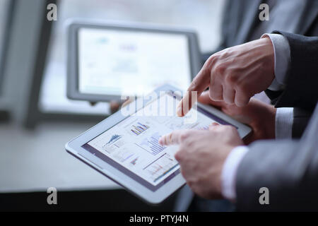 close up.two businessmen discussing financial data using a digital tablet Stock Photo