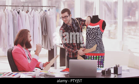 two fashion designers are working on creating women's clothing in the Studio Stock Photo