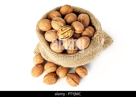 Whole walnuts (in shell) in burlap sack isolated on white background Stock Photo