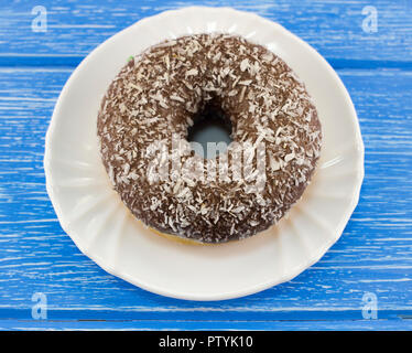 chocolate donut on a blue wooden background Stock Photo