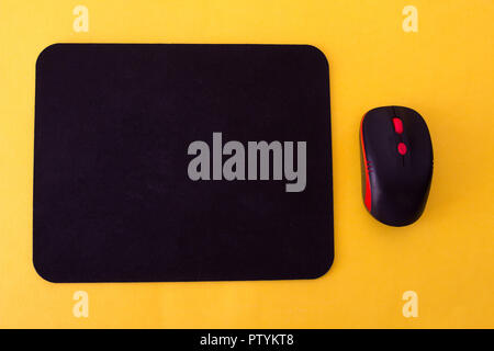 Computer mouse pad and mouse on a yellow background Stock Photo
