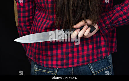 Young woman holding knife behind back Stock Photo: 26829459 - Alamy