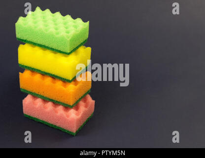 multicolored sponges for washing on a blue background Stock Photo