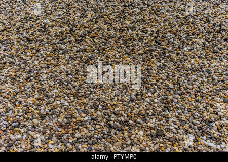 Natural background of small colored pebbles on the beach Stock Photo