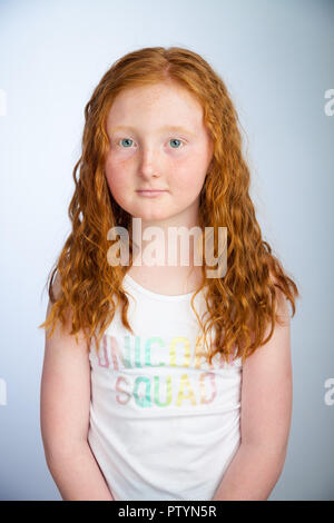 Portrait of a 10 year old girl with ginger hair and freckles. Stock Photo