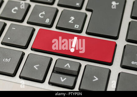 Red exclamation mark key on computer keyboard. Stock Photo