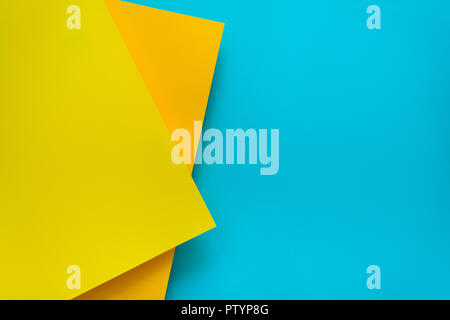 Blue and yellow pastel color papered background. Volume geometric flat lay. Top view. Copy space Stock Photo